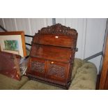 An Eastern carved hardwood hanging wall cabinet wi