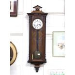 A late Victorian walnut single hole wall clock by