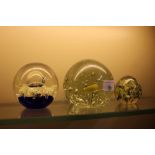 A Victorian green glass paperweight and two other