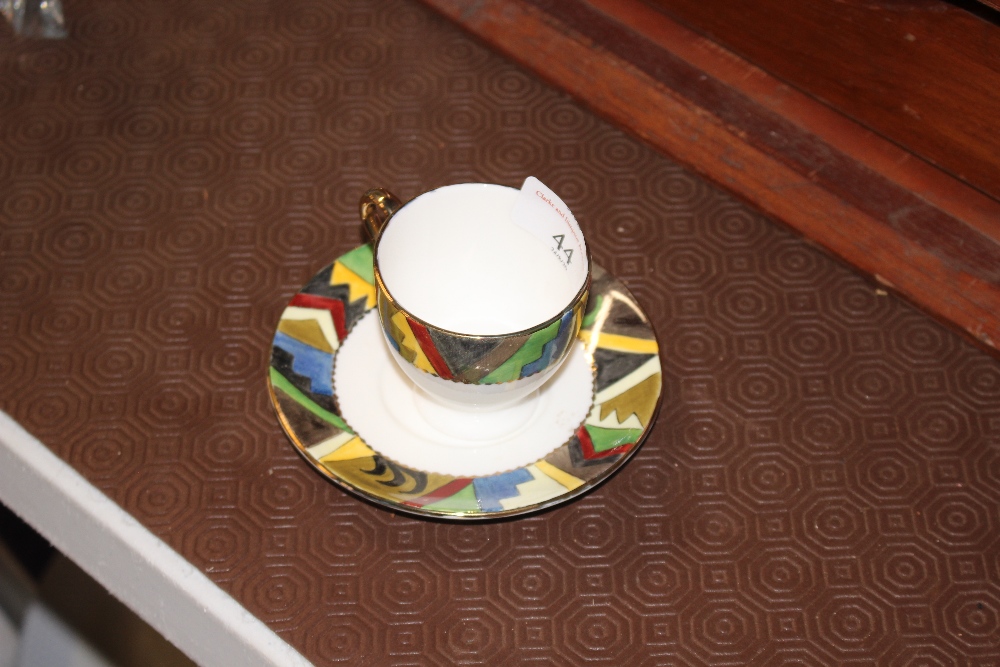A Royal Doulton hand painted coffee cup and sauce