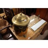 An ornate brass coal box raised on three paw feet