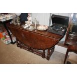 A large oak double action gate leg dining table