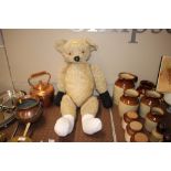 A large vintage Teddy bear with adjustable arms an