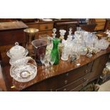 A large quantity of various glass decanters; bowls