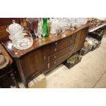 A reproduction mahogany serpentine front sideboard