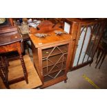 An Edwardian satin wood and glazed cabinet