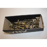 A box of miniature brass candlesticks