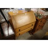 A light oak two drawer bureau