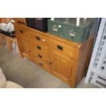 A light oak multi drawer sideboard