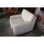 A stripped upholstered armchair