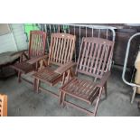 A set of three folding teak garden chairs
