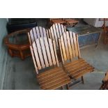 A set of four teak garden chairs