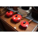 Two Le Creuset cooking dishes and one other simila