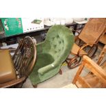 A green upholstered button back bedroom chair