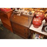 An oak bureau fitted three drawers