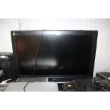 A Sony Bravia flat screen television with remote c