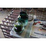 Two coloured glass vases on stands