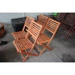 A set of four FSC folding teak garden chairs