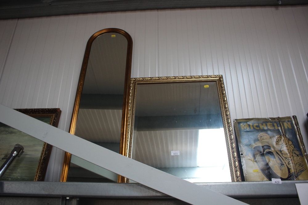 A bevel edged wall mirror; and a gilt framed oblon