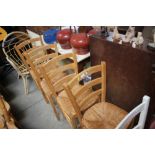A set of four beech ladder back dining chairs