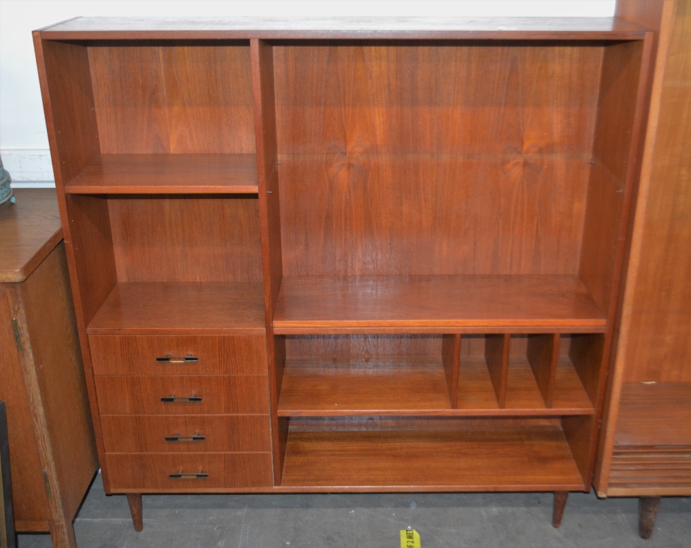 A teak wall unit, fitted adjustable bookshelves,