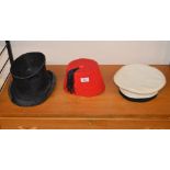 A vintage top hat; a sailor's hat and a fe