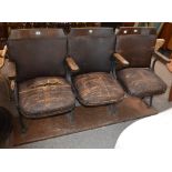 A set of three vintage cinema seats