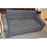 A low charcoal grey two seat sofa, raised on round