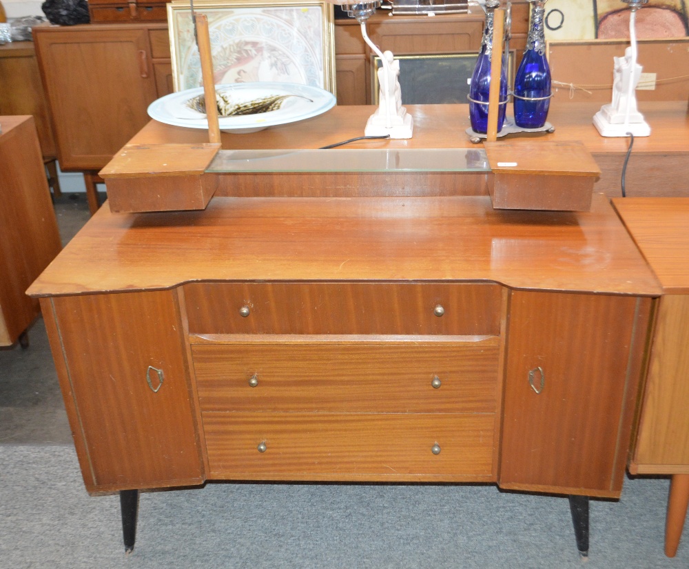 A teak dressing table, fitted four central drawers