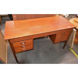 A teak G plan style kneehole desk, fitted six draw