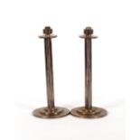 A pair of plated candlesticks, of tri-section form