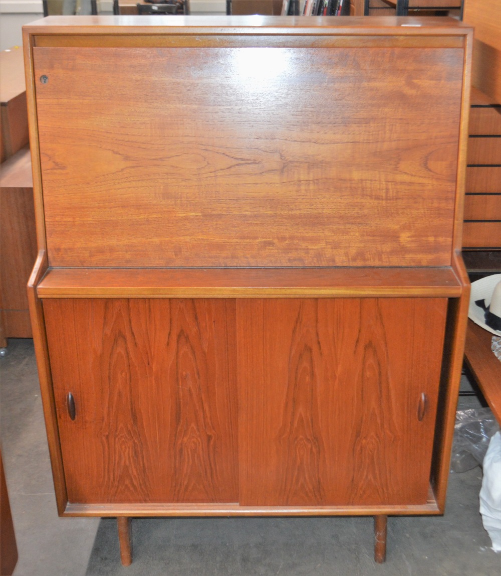 A teak cocktail cabinet by Herbert E. Gibbs, the fall front opening to reveal