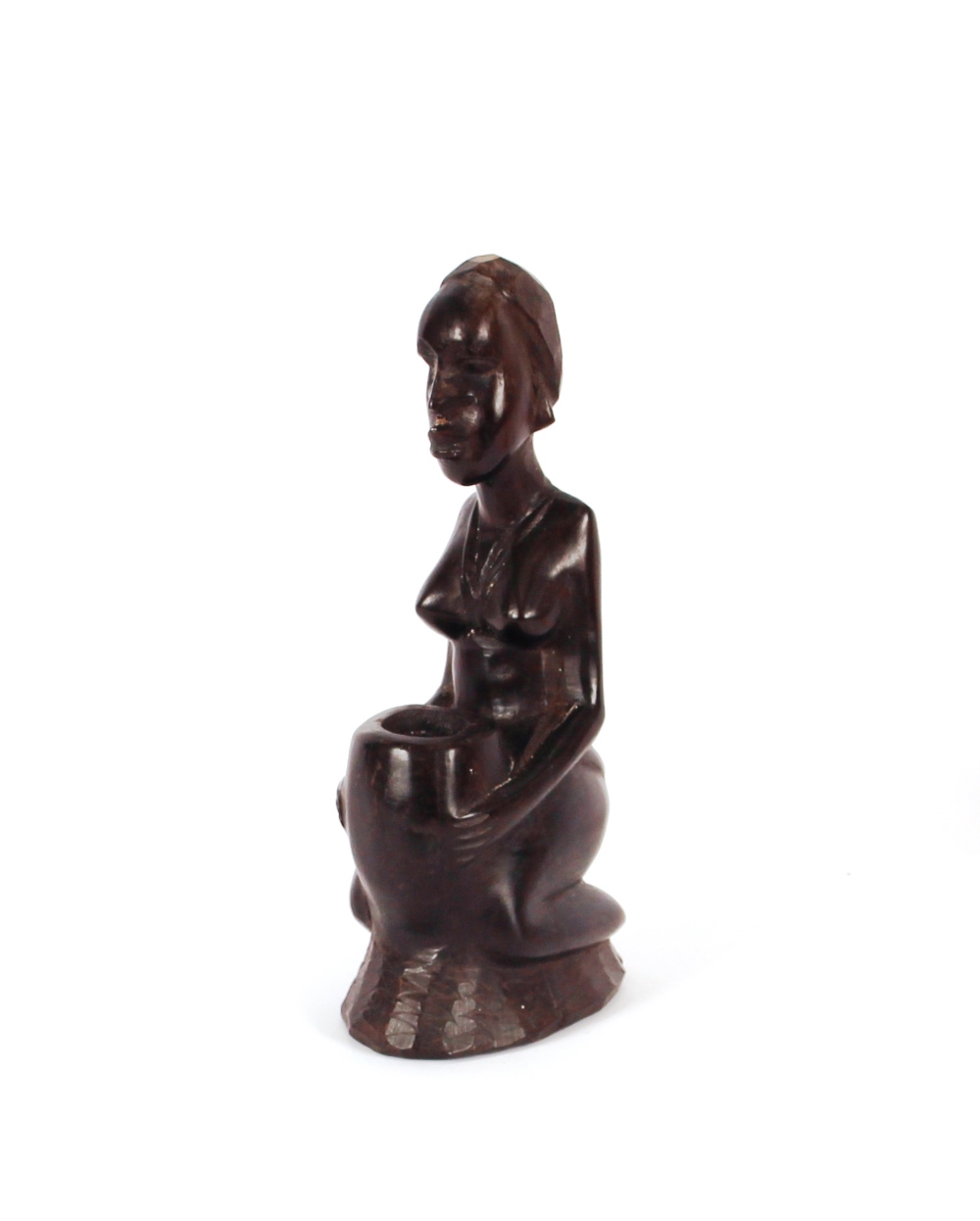 A carved hard wood African Art candle holder, in t