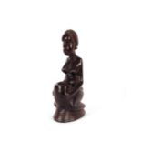 A carved hard wood African Art candle holder, in t