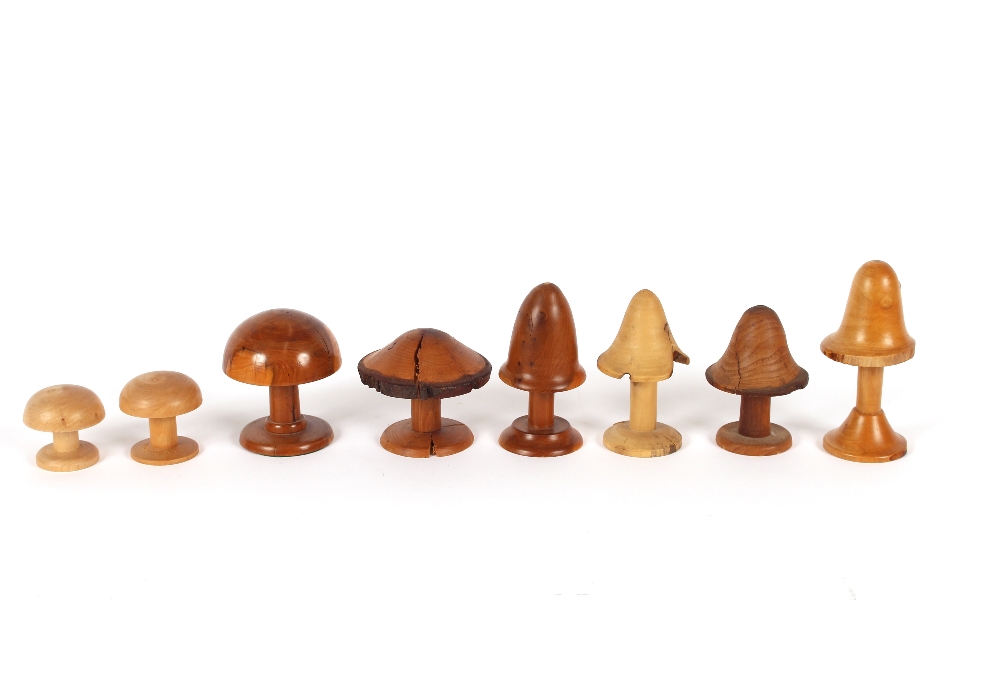 Eight treen mushrooms