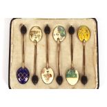 A cased set of six silver gilt and enamel decorate