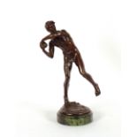 A bronze figure of a shot putter, on circular marb