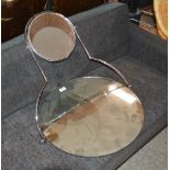 A chrome framed circular double framed swing toile