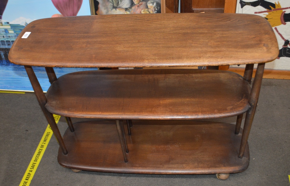 An Ercol three tier dark elm trolley, 86cm wide x