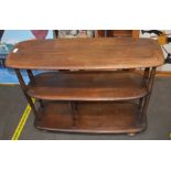 An Ercol three tier dark elm trolley, 86cm wide x