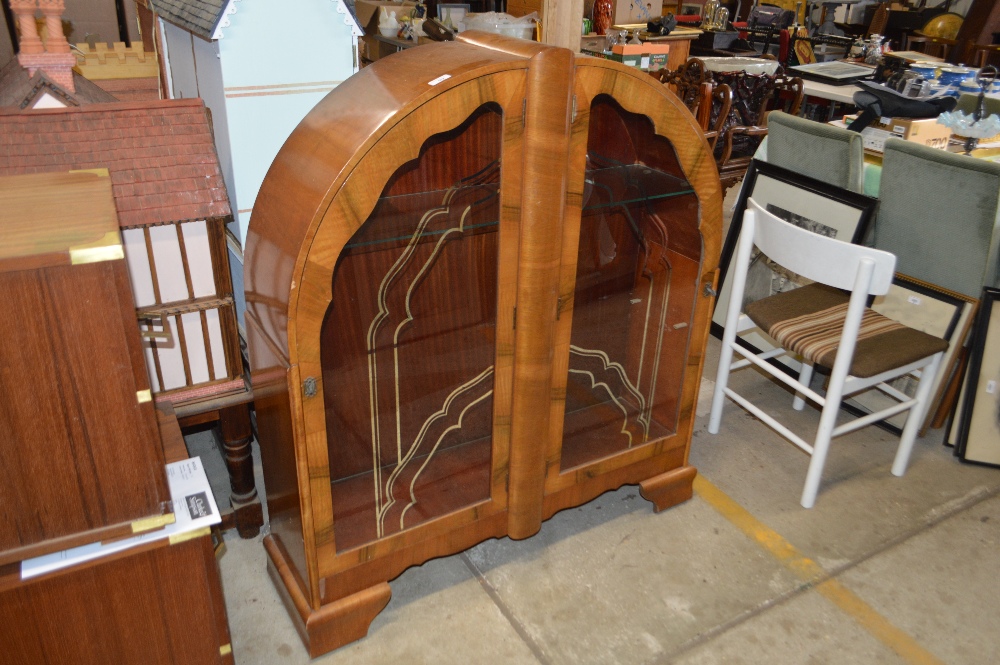 An Art Deco walnut display cabinet, of arched form