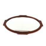 An Arts & Crafts design oval oak framed wall mirro