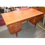 A teak G plan design knee-hole desk, fitted six dr