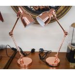 A pair of copper angle poise lamps