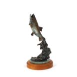 A large bronze study of a leaping fish, raised on