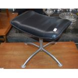 An Eames type leather and steel stool