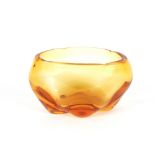 A heavy amber glass fruit bowl of oval form, 25.5c