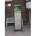 A full length double sided mirror on industrial ty