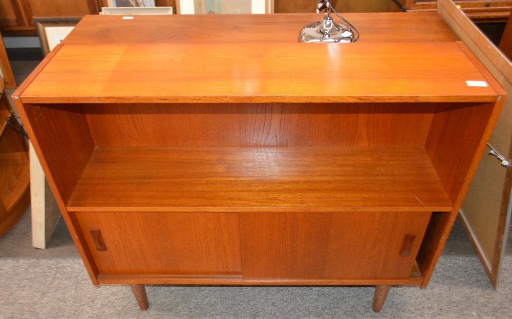 A teak side cabinet enclosed by sliding doors, rai