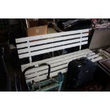 A white painted wooden and metal garden bench